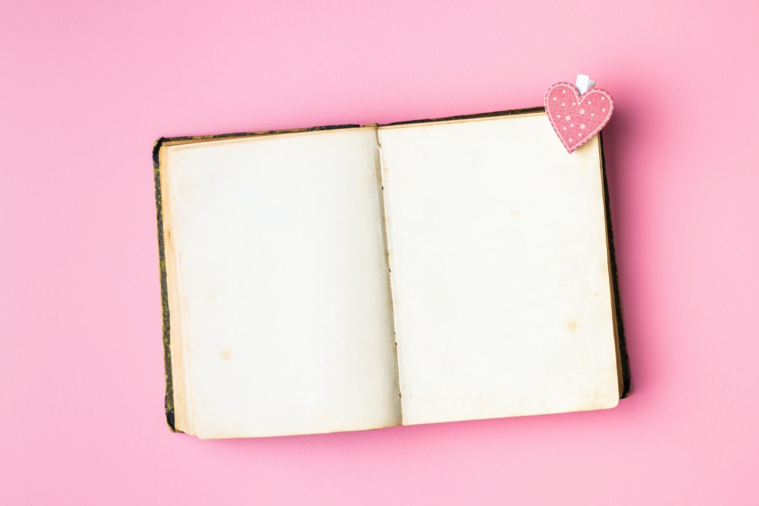 Love concept. Heart on open vintage book.
